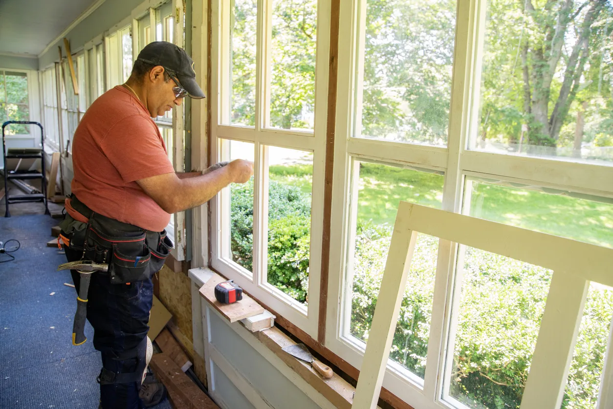 Professional window installer working on mounting windows